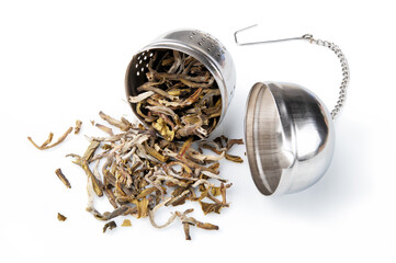 Tea strainer with Vietnamese tea, Smokey Shan Tea isolated on white background, close-up.