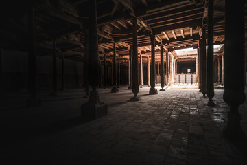 Interior inside the ancient Juma mosque with wooden carved mosaic columns, in the ancient city of...