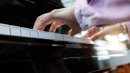 Close up of woman hands playing piano