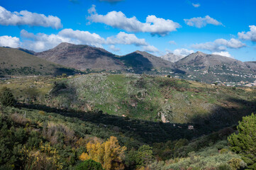 Panoramic view over the rough mountains with houses and blue sky, Sicily, Italy