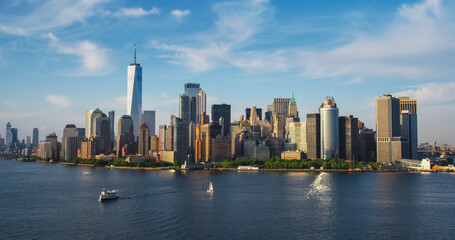 Naklejka premium Panorama Around the Wall Street Financial District in New York City, USA. Aerial Shot with Office Buildings and Skyscrapers on a Summer Sunny Day with Blue Sky and Light Clouds