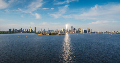 Aerial Shot of the Statue of Liberty with Lower Manhattan Skyline Cityscape with Wall Street Office...