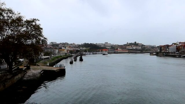 Rabelo boats moored on Douro River side in Porto city, pan right view