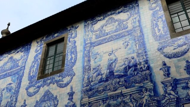 Jesus life scenes represented in blue tiles in Capela das Almas exterior facade, Porto