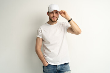 Handsome man wearing blank white cap and white t-shirt isolated on white background.