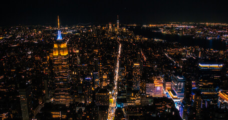 Helicopter Tour of New York City Architecture at Night. Manhattan with Panorama of Office Buildings...