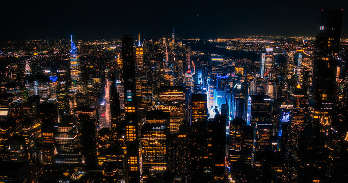 Scenic Aerial New York City View of Downtown Manhattan Architecture. Panoramic Night Photo of the Business District from a Helicopter. Cityscape with Office Buildings and Busy Traffic on Streets