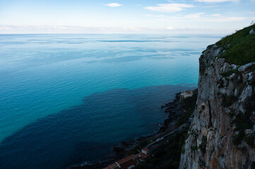 High angle view over a steep cliff and the blue sea at Cefalu, Italy