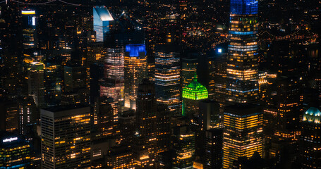 Scenic Aerial New York City View of Downtown Manhattan Architecture. High Angle Night Shot of the Business District from a Helicopter. Cityscape with Office Buildings and Busy Traffic on Streets