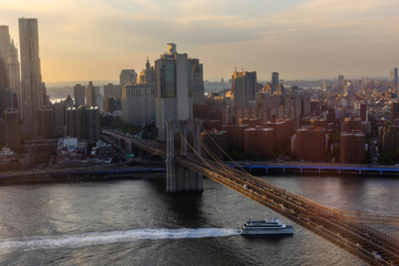 Iconic New York City Landscape Over East River with Skyscrapers, Brooklyn Bridge, Cars and Ferry...