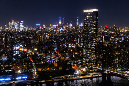 Scenic Aerial New York City View of Downtown Manhattan Architecture. Panoramic Photo of the Business District from a Helicopter. Cityscape with Buildings with Lights in Offices at Night