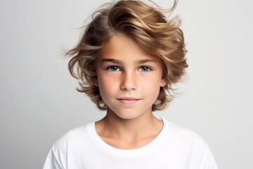 Portrait of a beautiful little girl with blond curly hair. Studio shot.