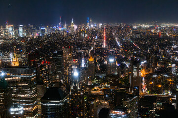 Fototapeta na wymiar Night Aerial Photo with New York City Skyscrapers with Lights in Office Rooms Inside. Helicopter View View Capturing Panorama of Manhattan