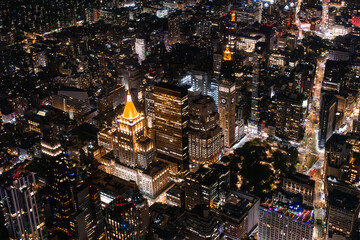 Scenic Aerial New York City View of Downtown Manhattan Architecture. Panoramic Shot of the Business District from a Helicopter. Cityscape with Buildings with Lights in Offices at Night