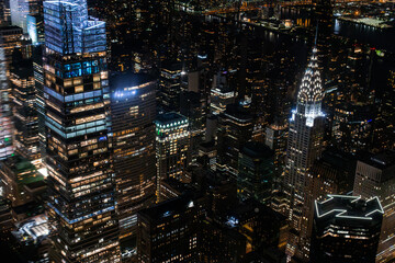 Fototapeta na wymiar New York City Aerial Night Cityscape with Stunning Manhattan Landmarks, Skyscrapers and Residential Buildings. Helicopter Down View of the Urban Architecture