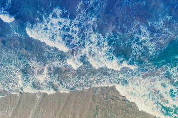 Top view of seascape with sandy beach. Surf line. Abstract nature landscape background