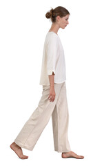 Woman in relaxed white clothing walking barefoot in a white room