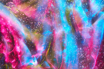 Beautiful neon magenta pink, purple, blue transparent space alien glitter slime background texture....