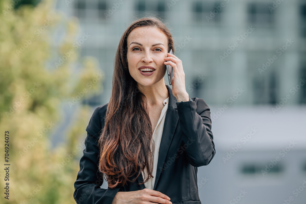 Wall mural business woman outdoors talking on mobile phone