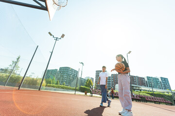 children schoolchildren playing a match about basketball against the background 