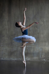 Young ballerina in a white tutu in a graceful pose