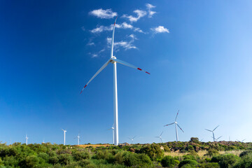 Wind turbine in mountains landscape. Eolic park windpower. Wind farm or New Wind green energy. Wind turbines alternative energy. Windmill power clean electricity generation in Sardinia, Italy