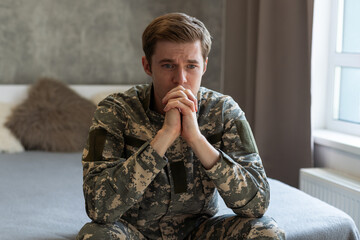 Stressed veteran soldier engrossed in depressive thoughts and memories. Sad depressed young...