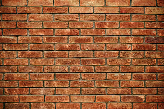 Fototapeta Close-up of a red brick wall with a detailed rustic texture, showcasing variations in color and pattern, perfect for backgrounds or design elements