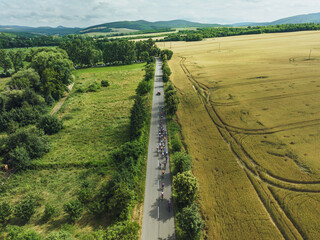 Top view of cycling races. Professional cyclists biking on the road.