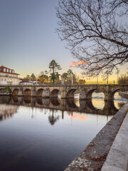 Fototapeta premium View of Trajan's Roman bridge, reflected on Tamega river, Chaves, Portugal