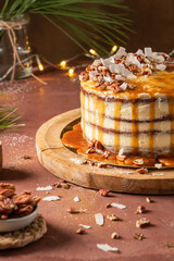 Delicious caramel cake with pecan nuts and coconut flakes