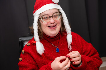 41 yo woman with the Down Syndrome,dressed as Santa Claus at home, Belgium
