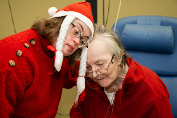 Tender family moment between a 41 yo woman with the Down Syndrome and her 85 yo mother during...