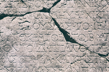 Retro text background. Fragment of broken ancient inscription (imperial law in ancient Greek...