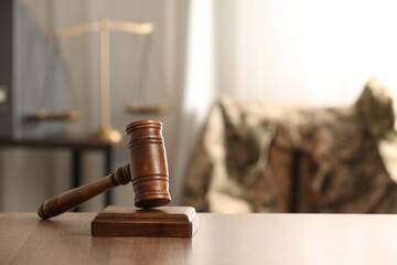 Law concept. Gavel on wooden table indoors, space for text