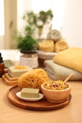 Dry flowers, loofah and soap bar on wooden table indoors, space for text. Spa time