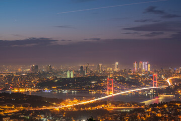 Istanbul Bosphorus Bridge at sunset and evening lights with colorful clouds in the sky