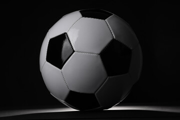 One soccer ball in darkness. Sports equipment