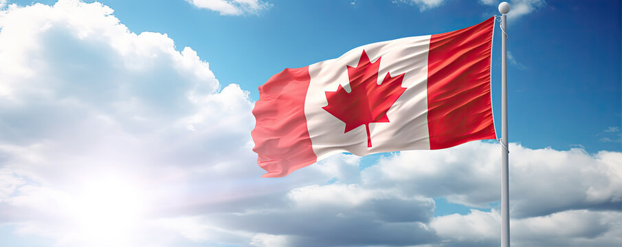 Canada flying flag on steel stick against blue sky.