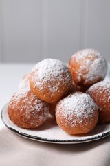 Delicious sweet buns with powdered sugar on table