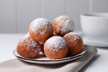 Delicious sweet buns with powdered sugar on table