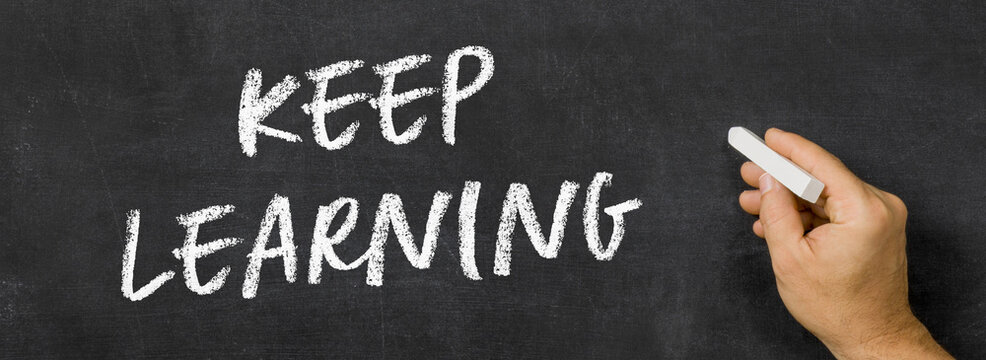  Text written on a blackboard -  Keep learning