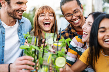 Multiracial friends group celebrating party toasting mojito outside - Happy young people enjoying...