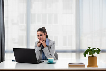 Young businesswoman adjusting to her new workplace after being promoted to a better position in a new office in a global business company.