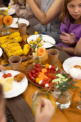 Happy kids and teens on birthday party at summer garden outdoors