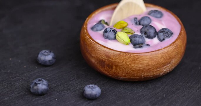 fresh purple and white yogurt with blueberries and blueberry berry flavor, delicious fresh yogurt made from milk with ripe blueberries