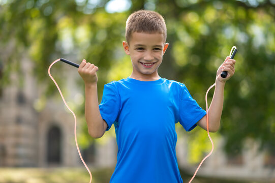 Fair-haired boy with a jumping rope in hands