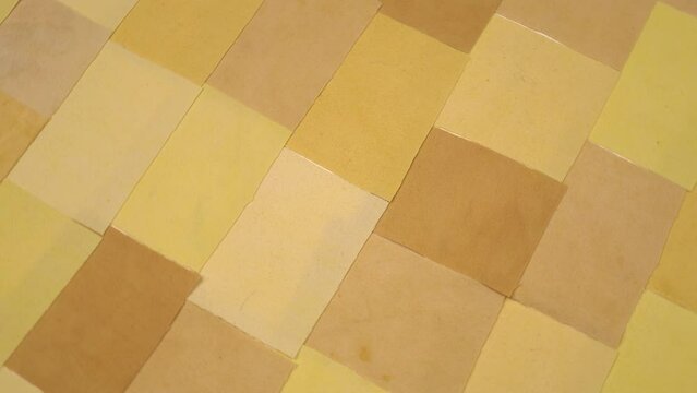 Handmade background in patchwork style with cotton fabric elements in yellow tones, background