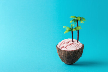 Coconut tropical island with ice cream and palm trees on blue background. Tropical beach concept. Creative minimal summer idea.