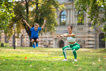 Fit woman and her son exercising in the park